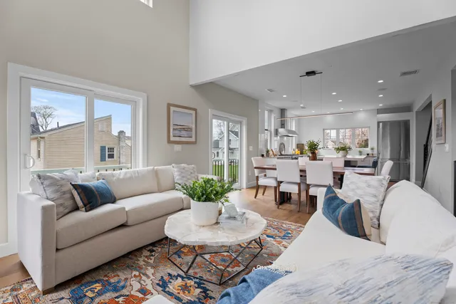 a living room with furniture kitchen and a table