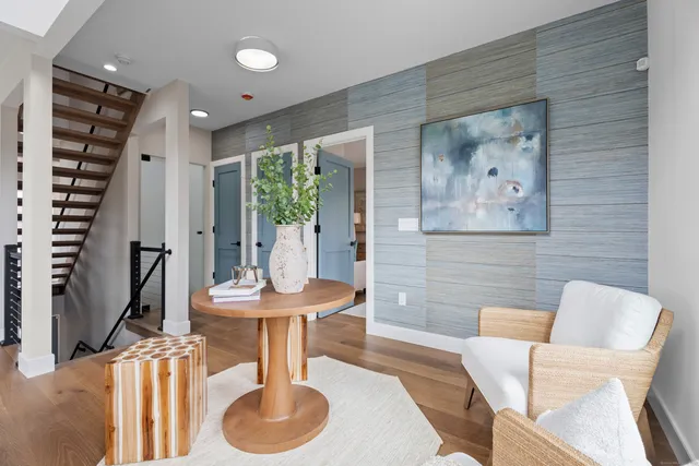a dining room with furniture and a floor to ceiling window