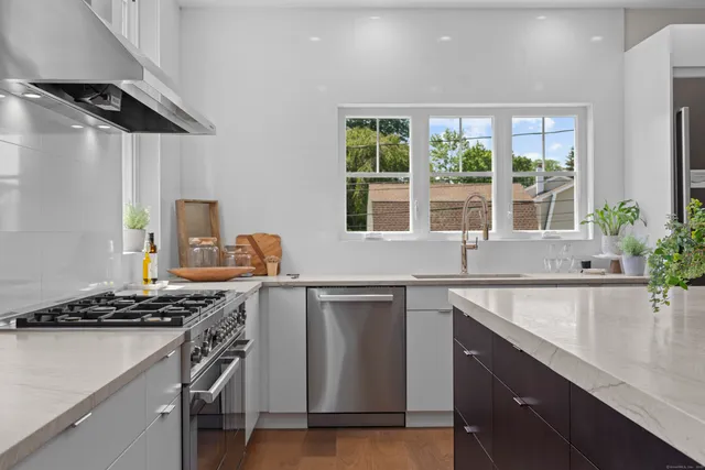 a kitchen with a sink stove and cabinets