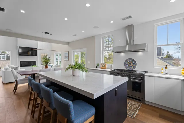 a kitchen with a stove a refrigerator and a dining table