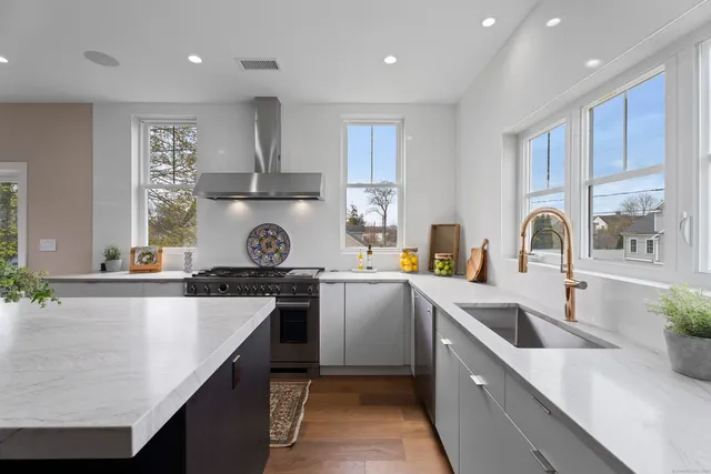 a kitchen with a sink stove and cabinets