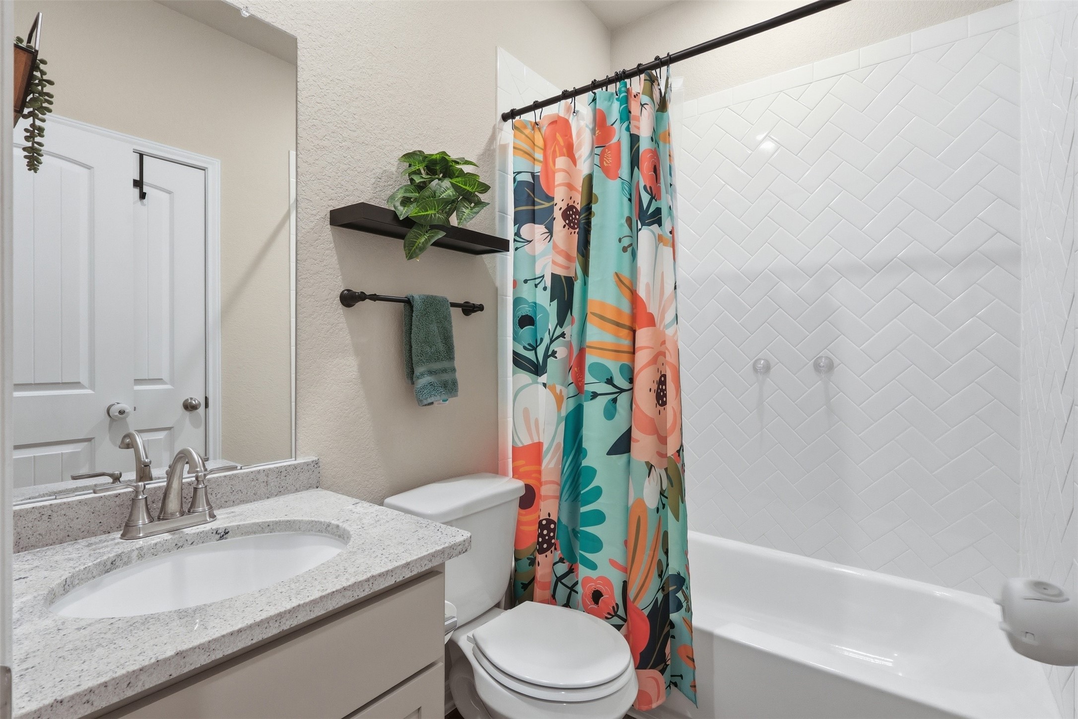 6310 Fawn Path Drive Conroe, TX 77303 - Photo 21 of 41 Full first-floor bathroom featuring a granite vanity, modern finishes, and a tub/shower combination for added convenience.