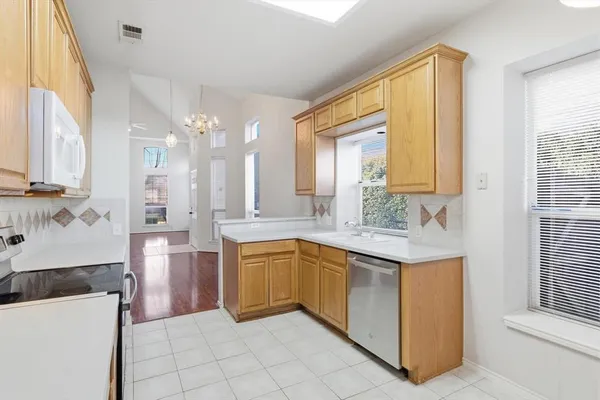 a spacious bathroom with a granite countertop sink a mirror and a bathtub