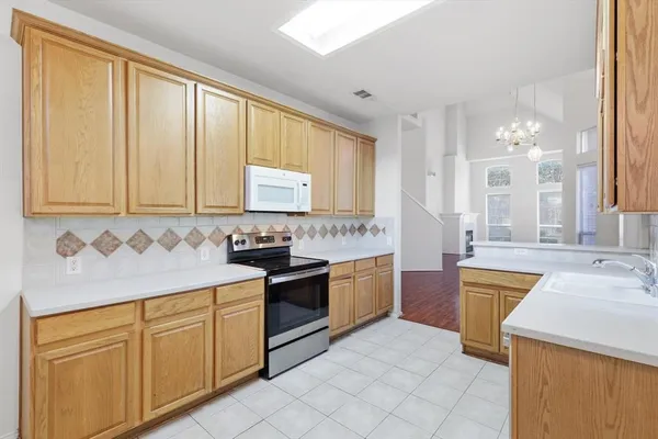 a kitchen with stainless steel appliances granite countertop a sink and cabinets