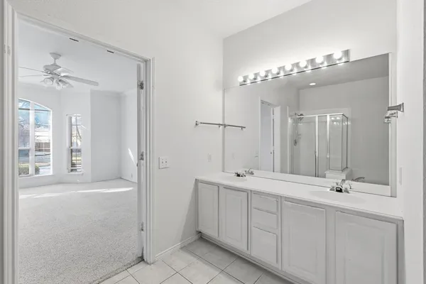 a bathroom with a double vanity sink mirror and