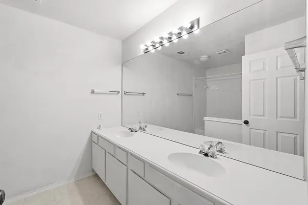 a bathroom with a double vanity sink mirror and vanity