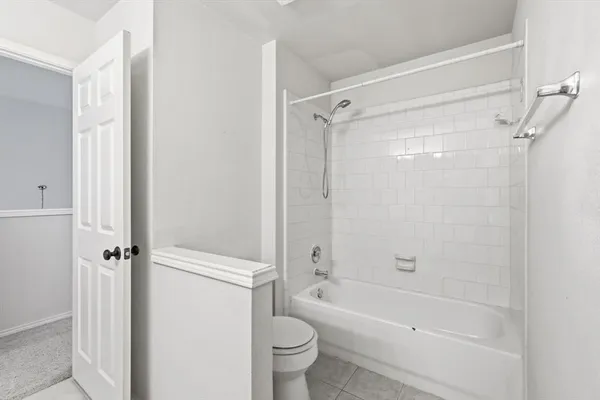 a bathroom with a shower a bathtub and a toilet