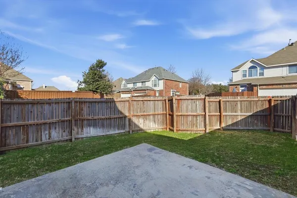 a view of a small yard with wooden fence