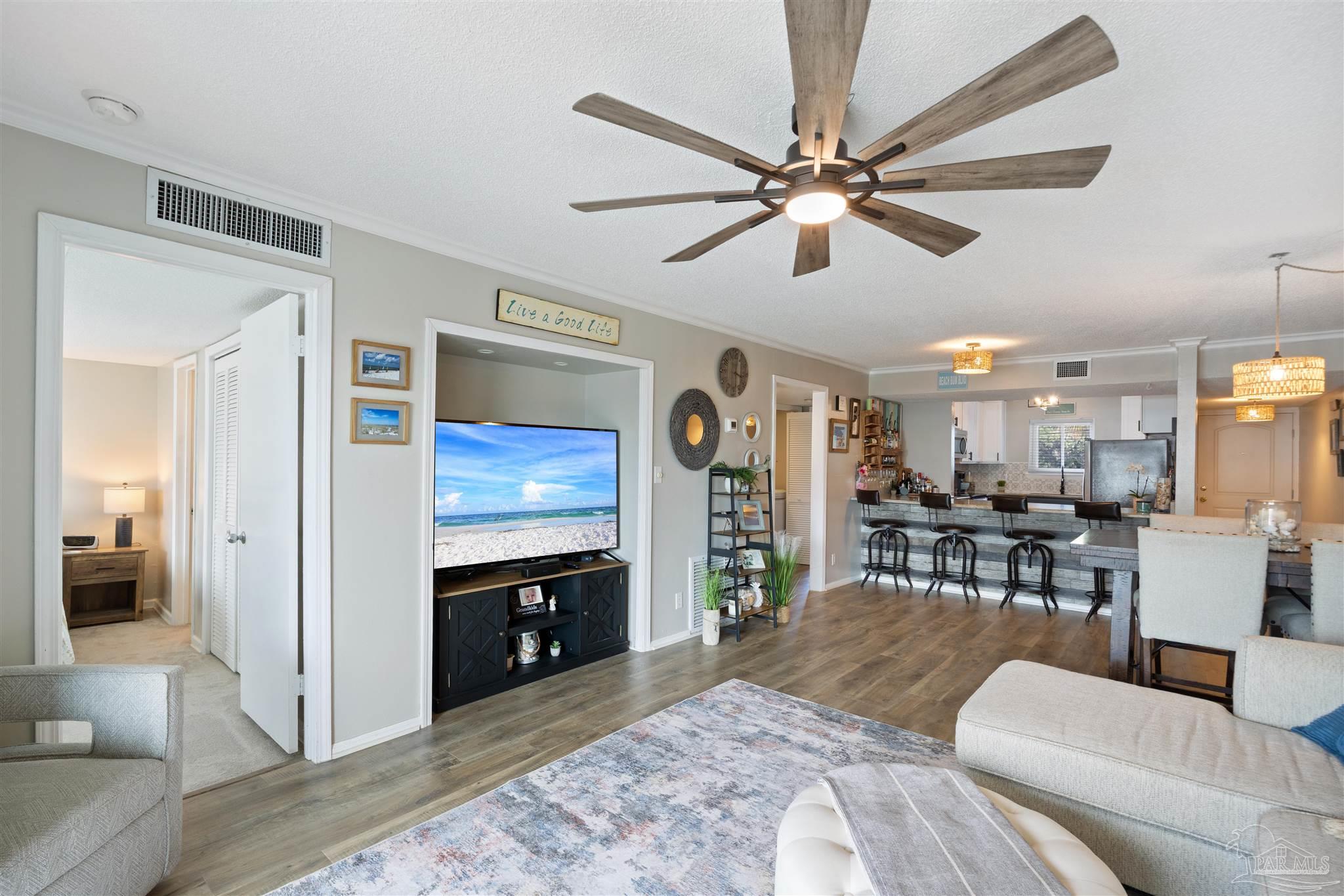 14100 River Road, Unit 122B Perdido Key, FL 32507 - Photo 16 of 46 a living room with furniture and a flat screen tv