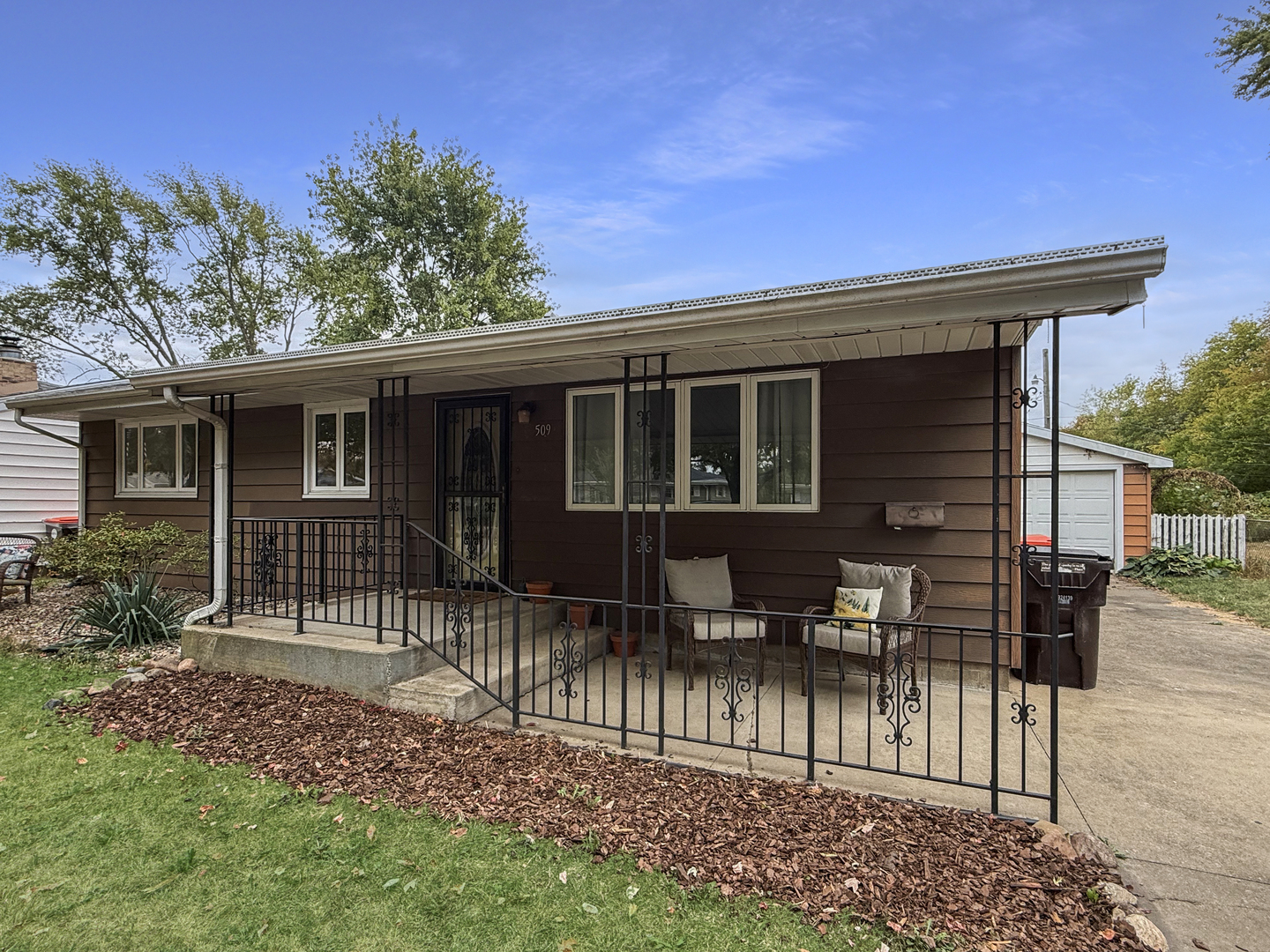 509 Broadmeadow Road Rantoul, IL 61866 - Photo 2 of 18 a view of house with a chairs and table in a patio