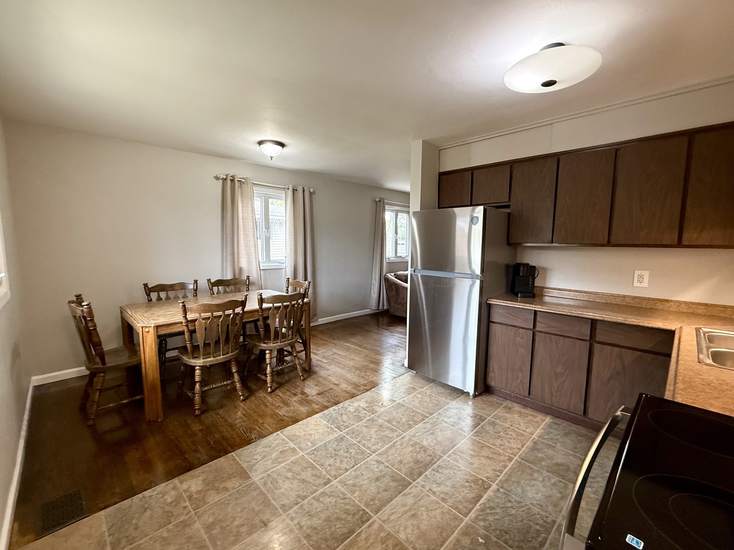 509 Broadmeadow Road Rantoul, IL 61866 - Photo 10 of 18 a kitchen with stainless steel appliances granite countertop a refrigerator a stove a dining table and chairs