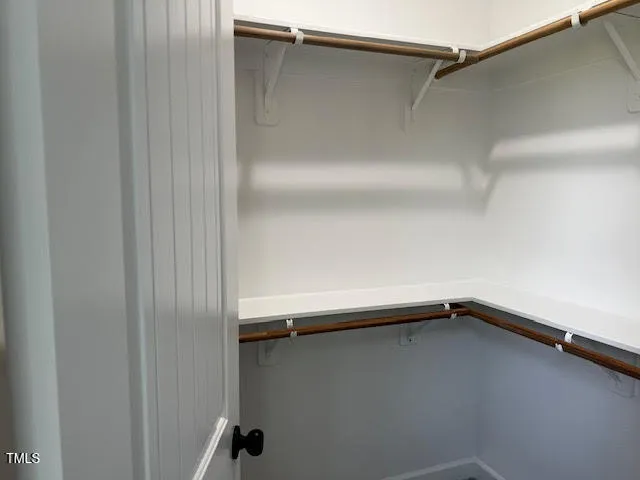 an empty room with closet and a bathroom