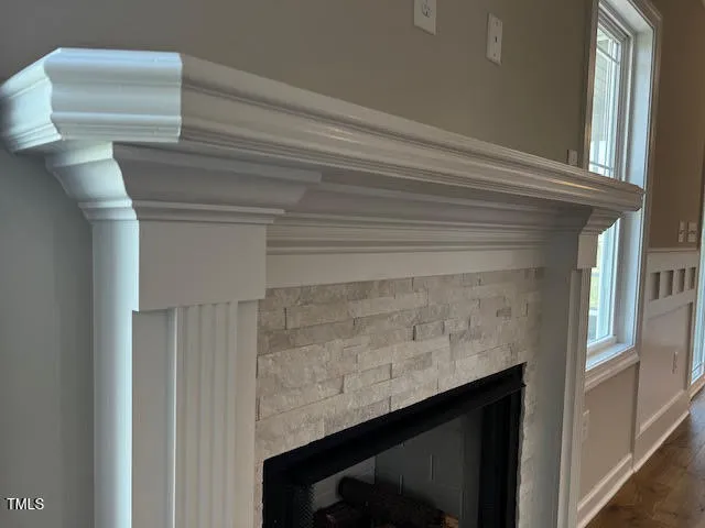 a view of a hallway with stairs and wooden floor