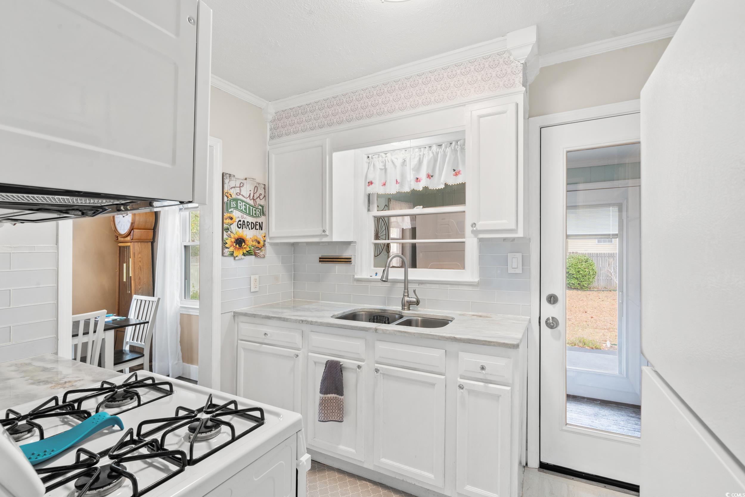 324 Edgewood Circle Conway, SC 29527 - Photo 11 of 31 Kitchen with white cabinets, white appliances, backsplash, ornamental molding, and range hood