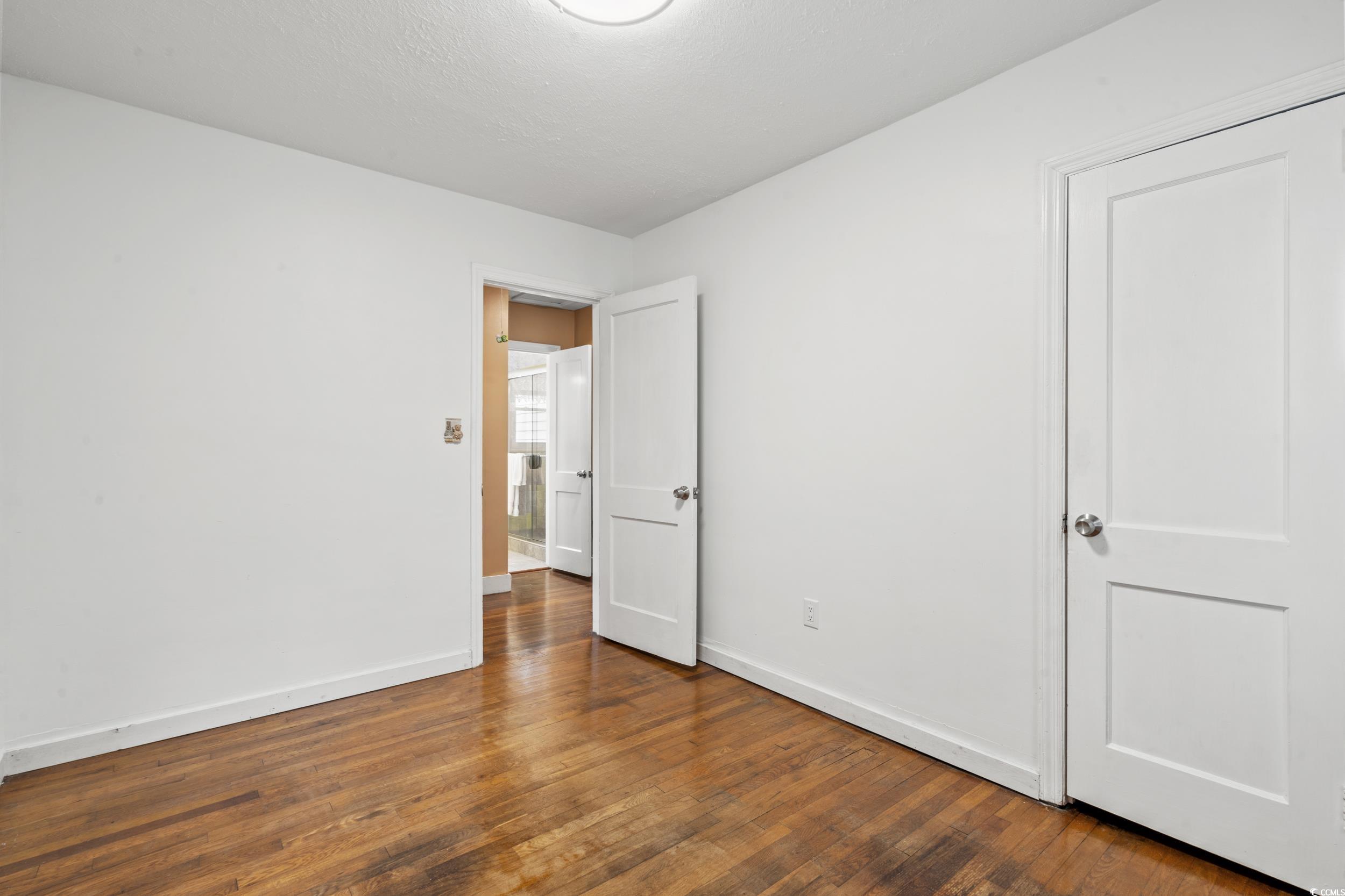 324 Edgewood Circle Conway, SC 29527 - Photo 16 of 31 Unfurnished bedroom featuring dark wood-style floors and baseboards
