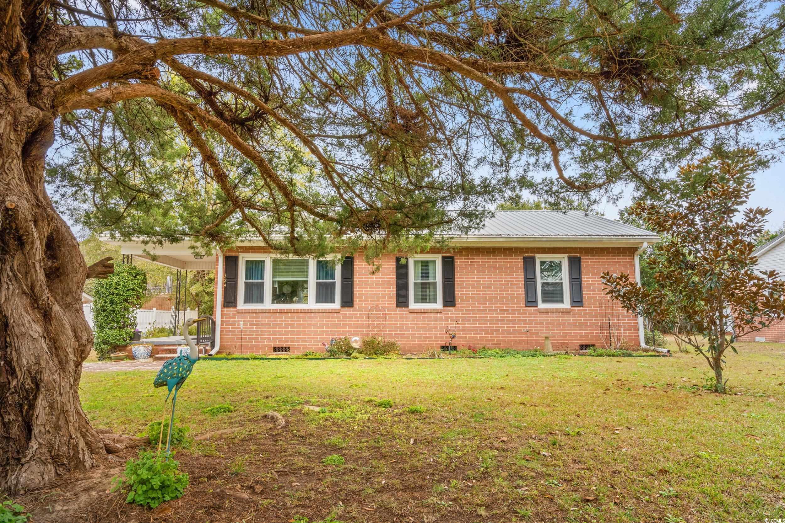 324 Edgewood Circle Conway, SC 29527 - Photo 2 of 31 View of front of property with crawl space, a front yard, a metal roof, and brick siding