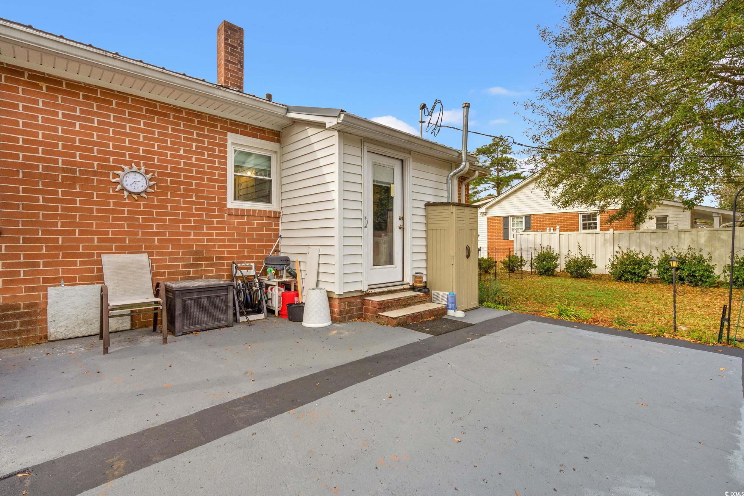 324 Edgewood Circle Conway, SC 29527 - Photo 25 of 31 Rear view of property featuring a patio, a chimney, brick siding, and entry steps