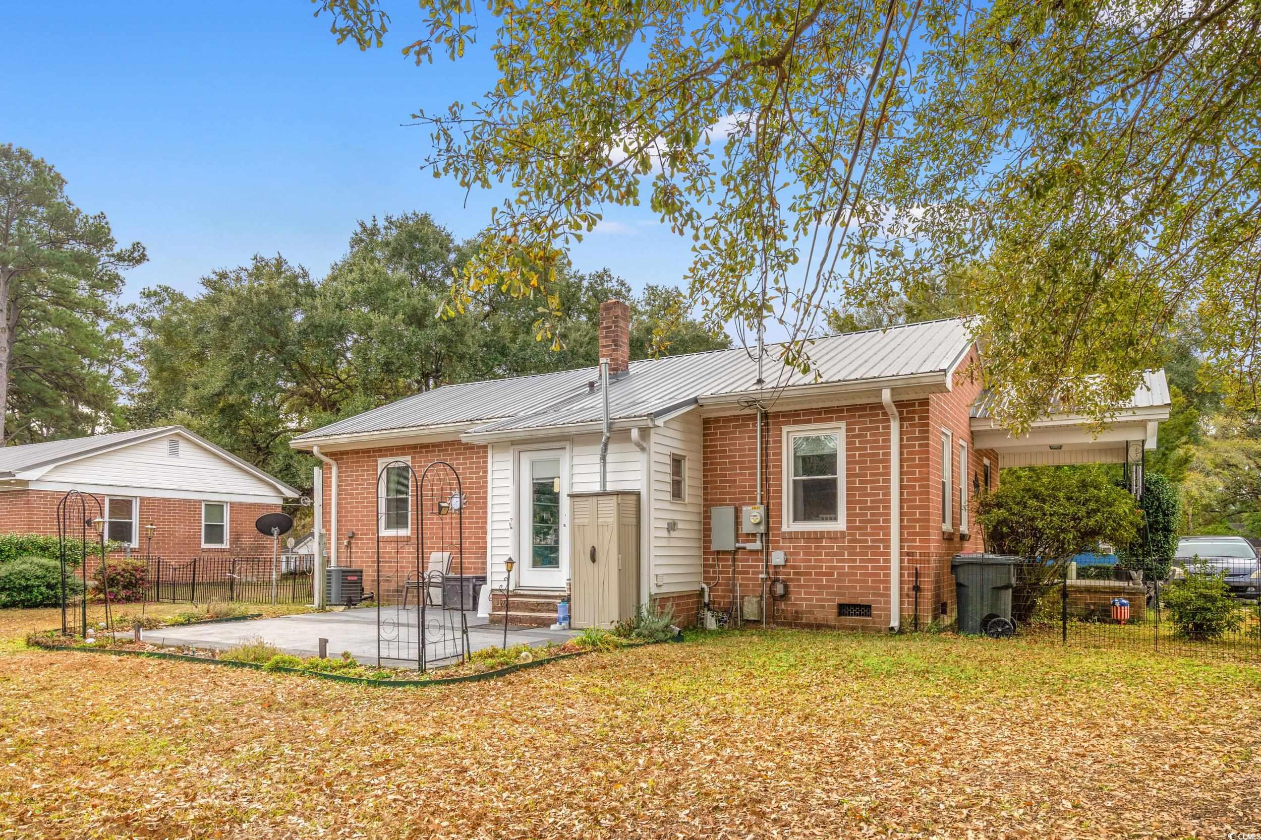324 Edgewood Circle Conway, SC 29527 - Photo 27 of 31 Rear view of property featuring a chimney, a patio area, brick siding, and crawl space