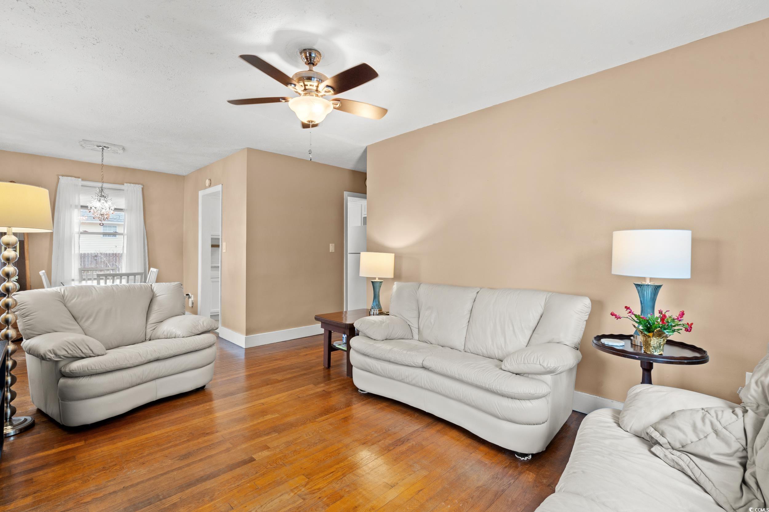 324 Edgewood Circle Conway, SC 29527 - Photo 7 of 31 Living room featuring wood-type flooring, ceiling fan, and a chandelier