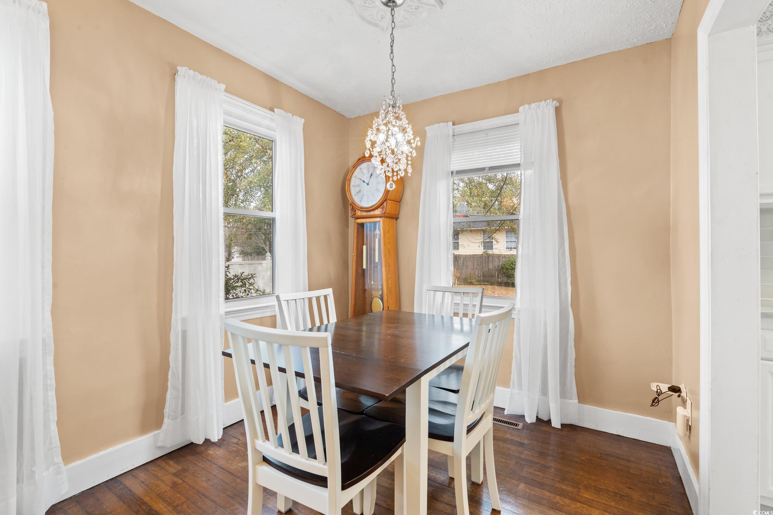 324 Edgewood Circle Conway, SC 29527 - Photo 8 of 31 Dining area featuring dark wood finished floors, healthy amount of natural light, and a chandelier