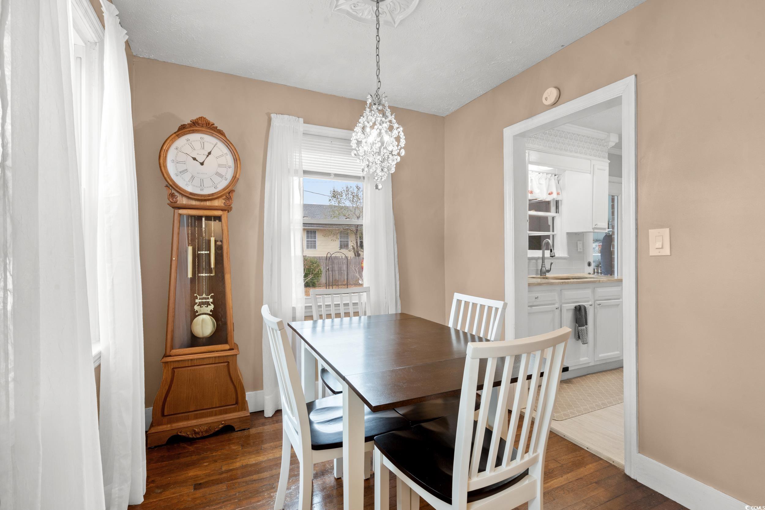 324 Edgewood Circle Conway, SC 29527 - Photo 9 of 31 Dining area featuring dark wood-type flooring and a chandelier
