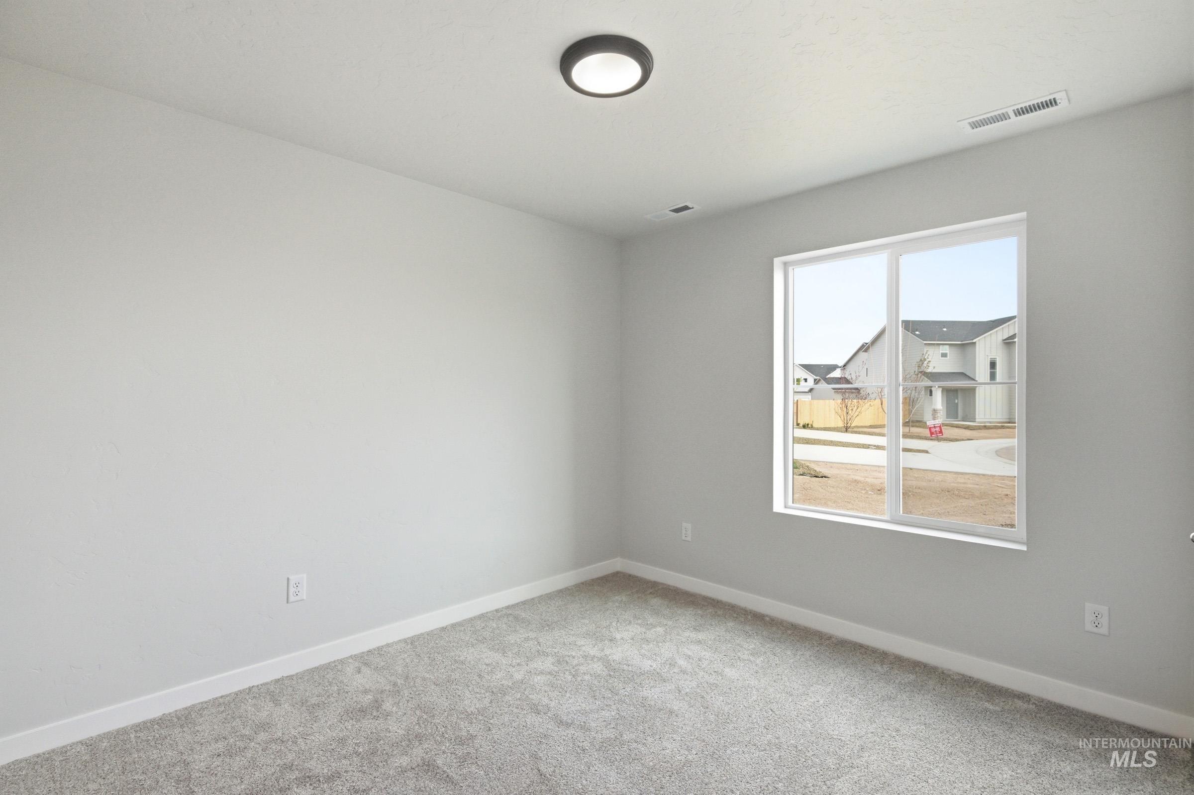 13735 Inman Court Caldwell, ID 83607 - Photo 11 of 20 Spare room with light colored carpet and baseboards