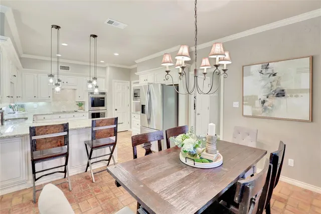 a view of a dining room and livingroom view with furniture wooden floor a chandelier
