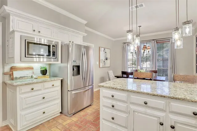 a kitchen with granite countertop cabinets stainless steel appliances and wooden floor