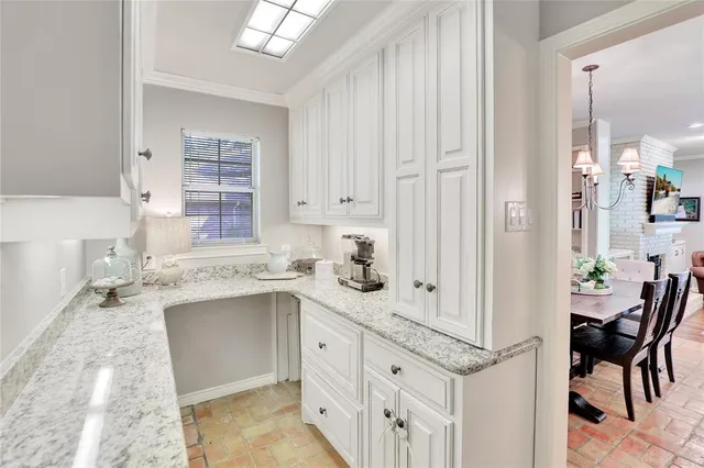 a kitchen with a sink window and cabinets