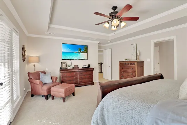 a bedroom with a bed and ceiling fan