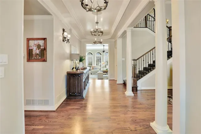 a view of entryway and hall with wooden floor