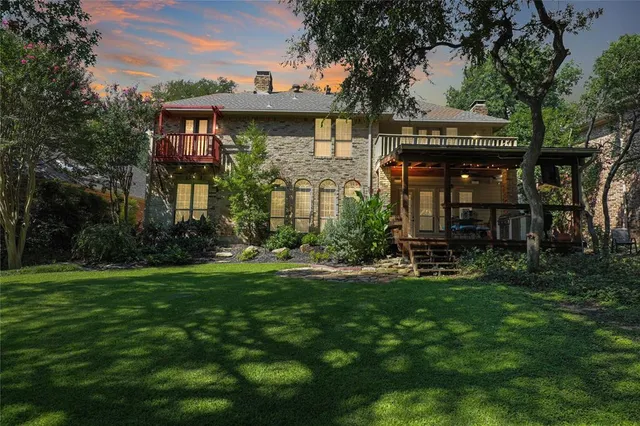 a view of a house with a yard and sitting area