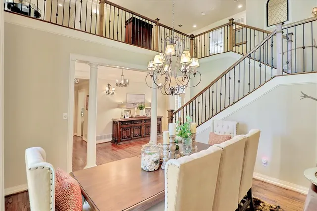 a view of livingroom and dining room with furniture wooden floor and windows