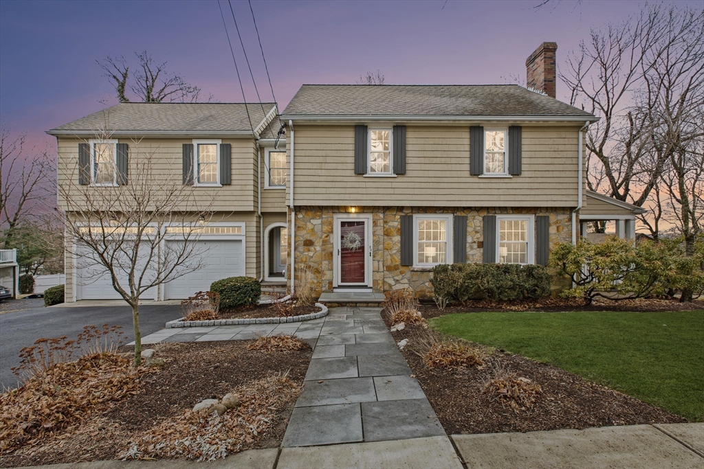 a front view of a house with garden