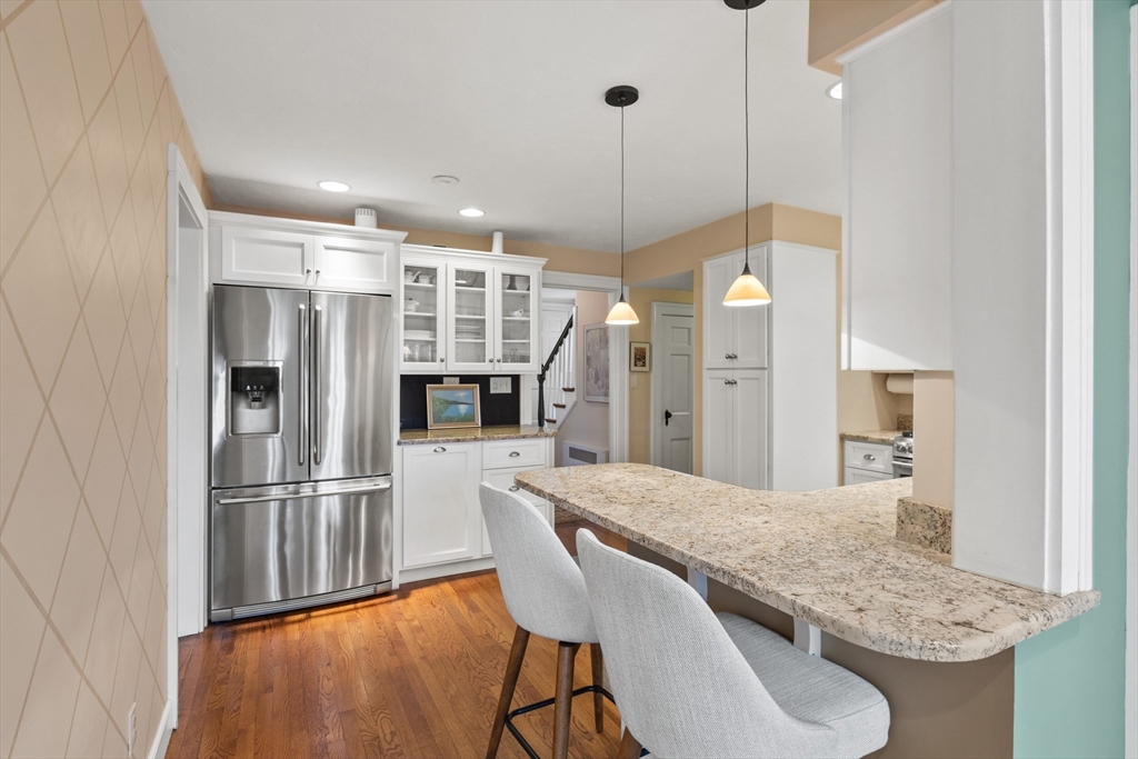 29 Allen Road Winchester, MA 01890 - Photo 16 of 42 a kitchen with stainless steel appliances granite countertop a refrigerator a sink dishwasher and a wooden floor