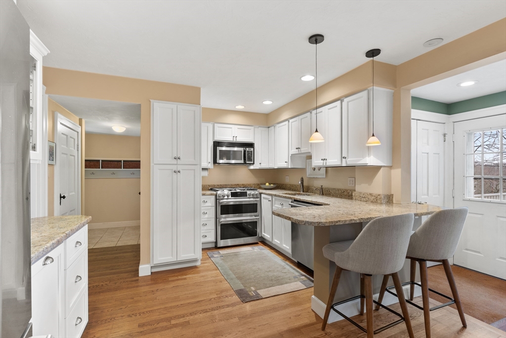 29 Allen Road Winchester, MA 01890 - Photo 17 of 42 a large kitchen with cabinets wooden floor and stainless steel appliances