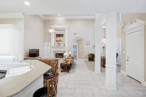 a living room with furniture a fireplace and a table
