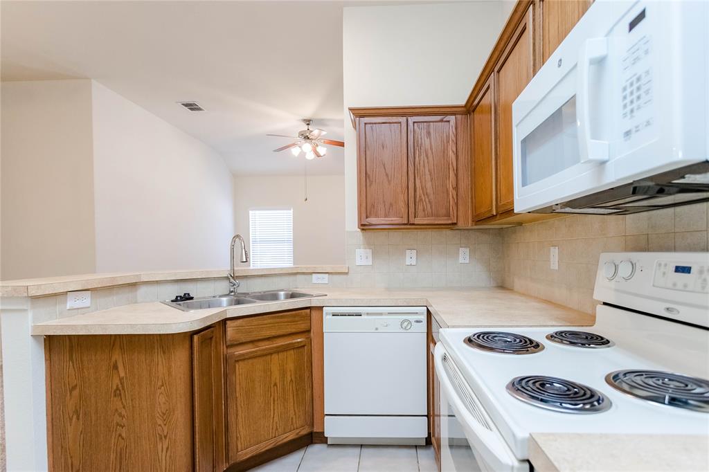 436 Blake Lane Midlothian, TX 76065 - Photo 12 of 26 a kitchen with a sink a stove and cabinets