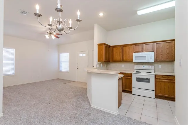 a kitchen with stainless steel appliances granite countertop a stove and cabinets