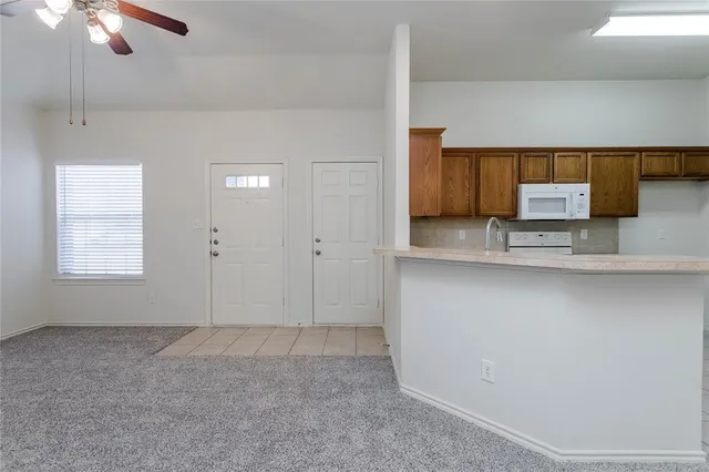 a view of a kitchen with a sink cabinets and a ceiling fan
