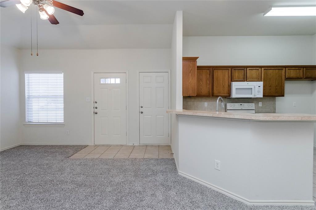 436 Blake Lane Midlothian, TX 76065 - Photo 17 of 26 a view of a kitchen with a sink cabinets and a ceiling fan