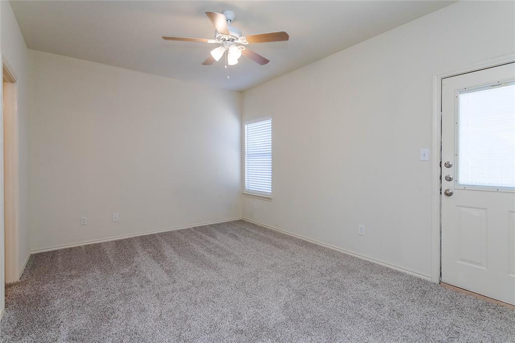 436 Blake Lane Midlothian, TX 76065 - Photo 22 of 26 an empty room with a chandelier fan and windows