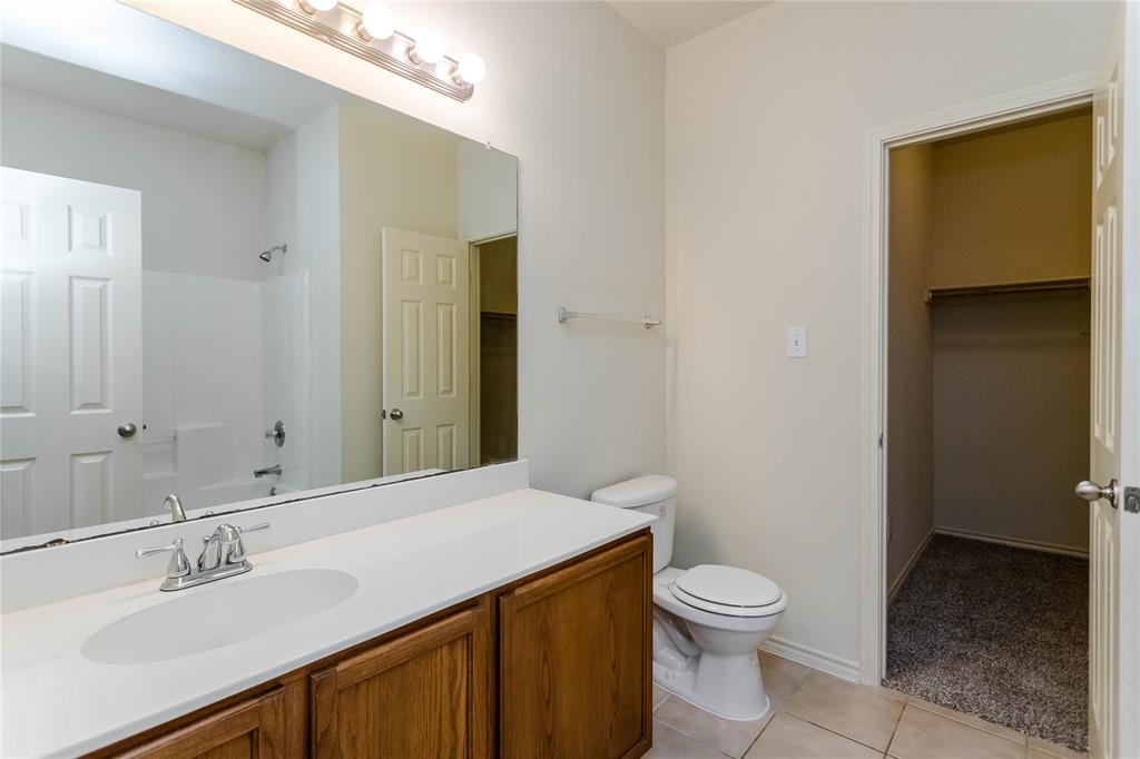 436 Blake Lane Midlothian, TX 76065 - Photo 23 of 26 a bathroom with a granite countertop sink toilet and shower