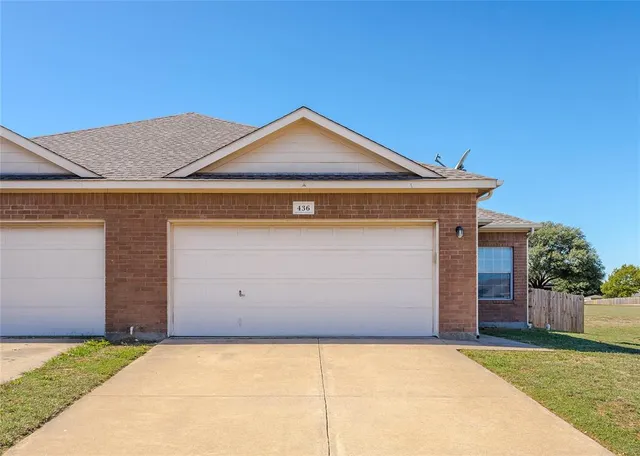 a front view of a house with garage