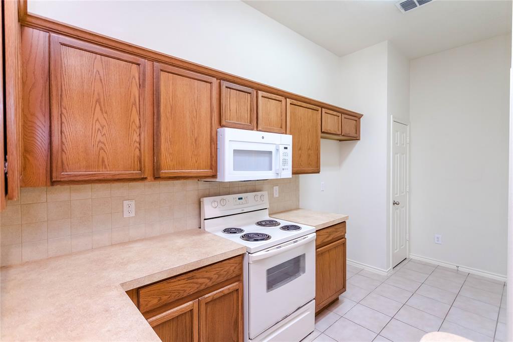 436 Blake Lane Midlothian, TX 76065 - Photo 8 of 26 a kitchen with a stove and a microwave
