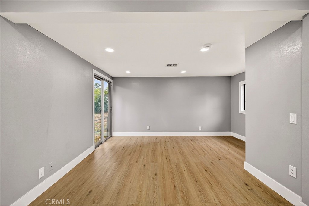 7040 Fulton Avenue Palermo, CA 95968 - Photo 13 of 53 a view of an empty room with wooden floor and a window