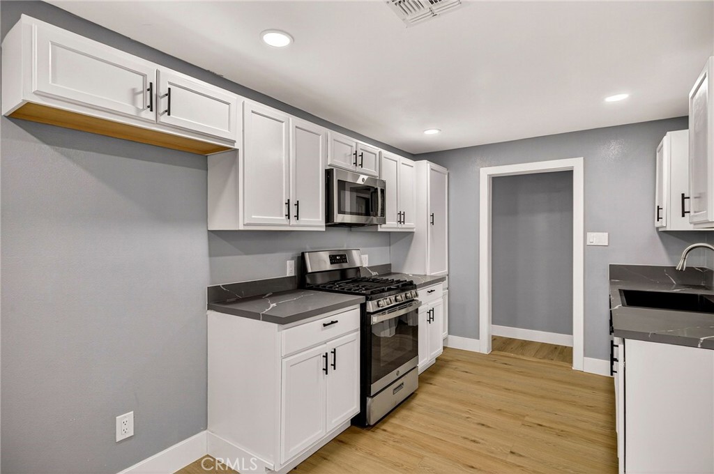7040 Fulton Avenue Palermo, CA 95968 - Photo 17 of 53 a kitchen with stainless steel appliances granite countertop a stove a sink and a refrigerator