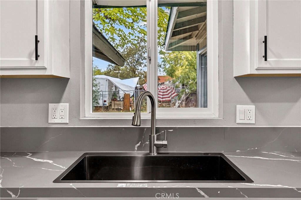 7040 Fulton Avenue Palermo, CA 95968 - Photo 19 of 53 a view of a sink a microwave and window in a kitchen