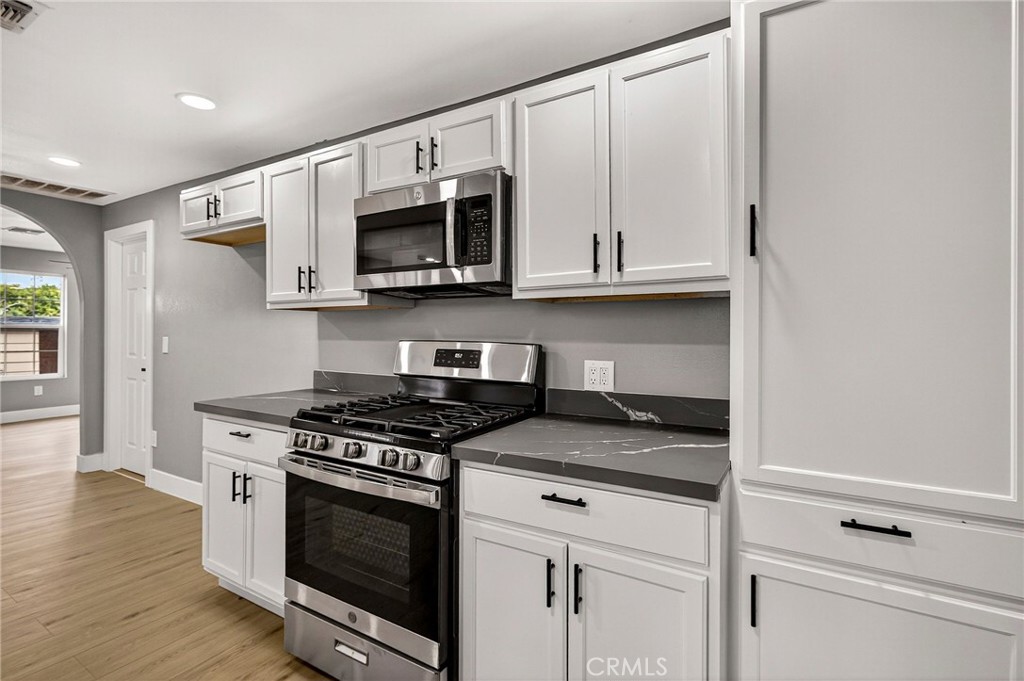 7040 Fulton Avenue Palermo, CA 95968 - Photo 21 of 53 a kitchen with stainless steel appliances granite countertop a stove and a microwave