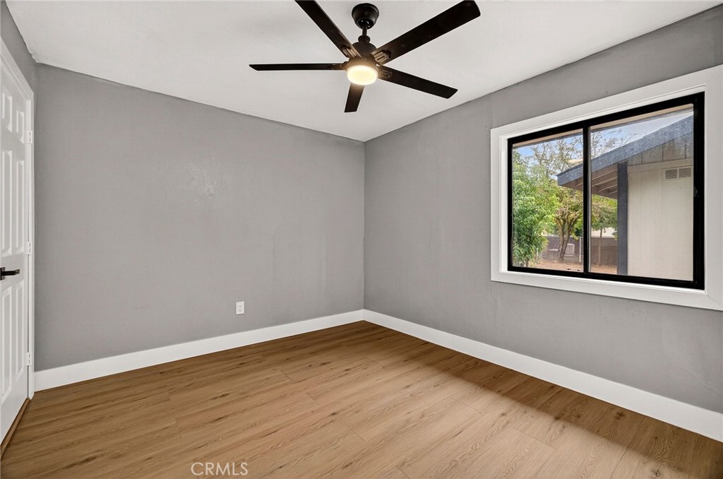 7040 Fulton Avenue Palermo, CA 95968 - Photo 22 of 53 a view of an empty room with a window and wooden floor